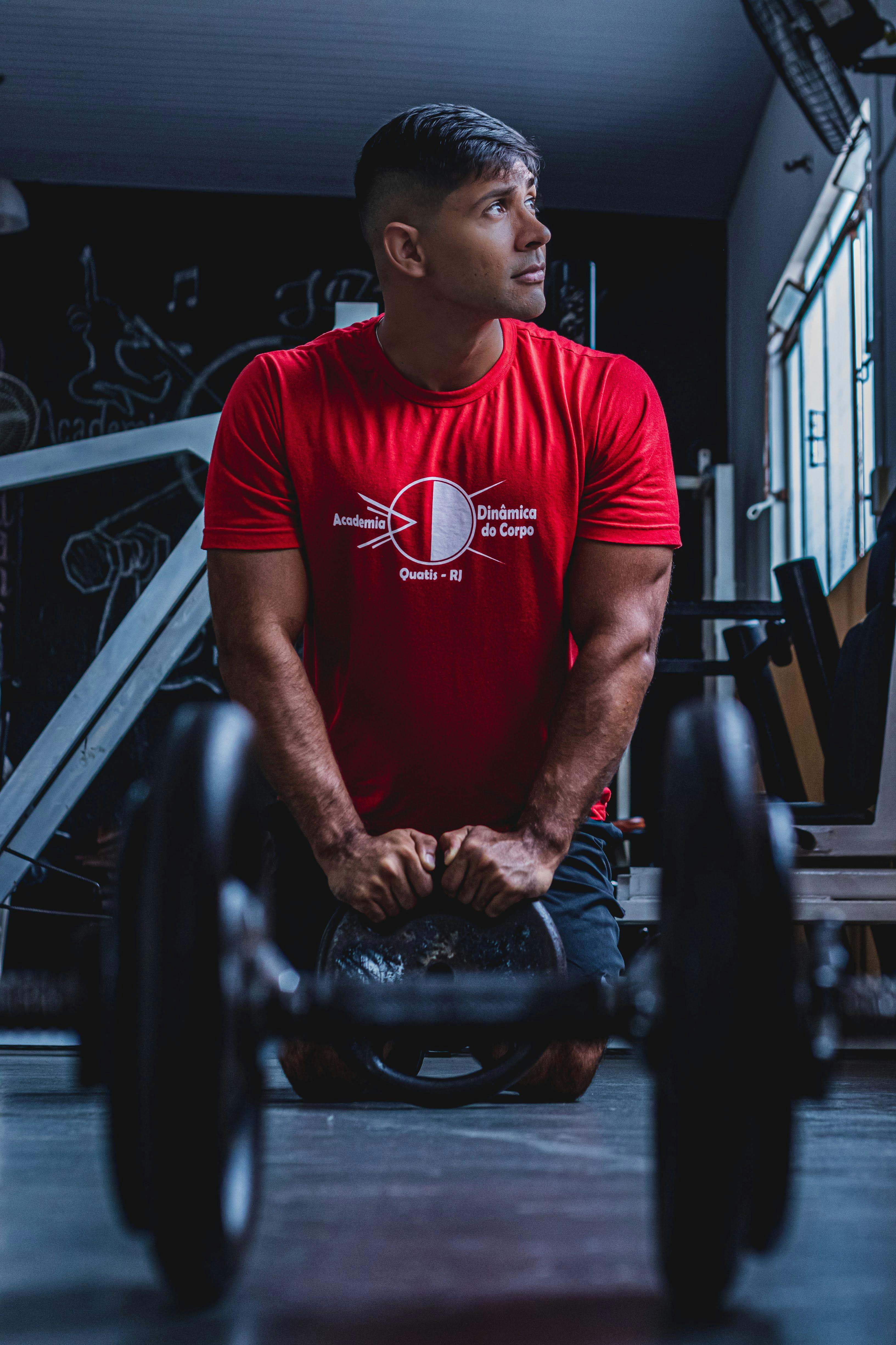 Young man working out with a kettlebell in a gym in Quatis, Brazil.